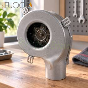 Ventilateur fumigène avec escargot en métal, boîtier rond et turbine visible sur établi